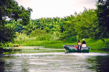 Kinabatangan, Malaysia - 09 May 2013: Tourists on a boat cruise along the river of Kinabatangan, some of the most diverse concentration of wildlife in Borneo.のeditorial素材