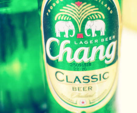 BANGKOK, THAILAND -OCTOBER 13, 2015: T Chang Beer Bottle on the Table in Bangkok on October 13,2014.のeditorial素材