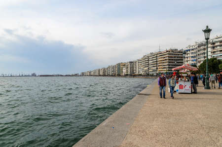 Thessaloniki, Greece - March 26, 2017: People walking on the coast in Thessaloniki next to the White tower.のeditorial素材