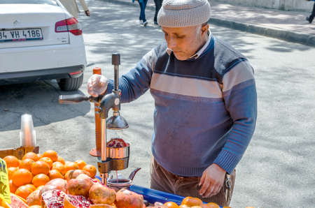 ISTANBUL, TURKEY - April 10, 2014: pomegranate juice prepared in street of Istanbul with old metal juice press squeeze machine. ISTANBUL, TURKEYのeditorial素材