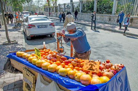 ISTANBUL, TURKEY - April 10, 2014: pomegranate juice prepared in street of Istanbul with old metal juice press squeeze machine. ISTANBUL, TURKEYのeditorial素材