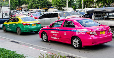 BANGKOK - OCTOBER 13: Colorful Bangkok taxis on the street October 13, 2015 in Bangkok.のeditorial素材