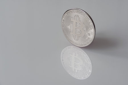 Mockup of digital currency silver Bitcoin (BTC) isolated on white with clipping path and smooth shadow.の写真素材