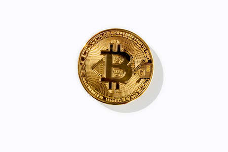 Golden bitcoin coin from cryptocurrency with shadow and isolated gray backgroundの写真素材