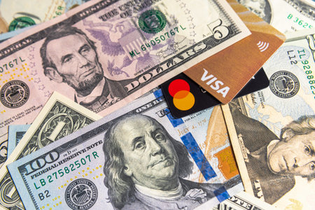 Moscow, Russia - 09 June 2021: Credit cards Visa and MasterCard lays on american dollars.のeditorial素材