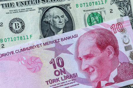 Close-up Turkish Ten Lira and US One Dollar banknotes as background.