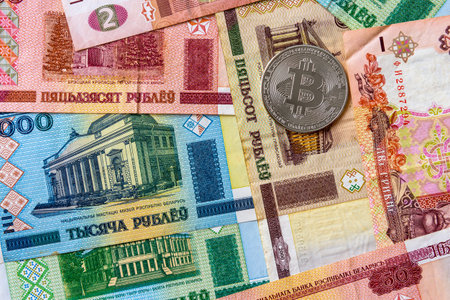 Paper denominations Belarusian ruble. Metal coins are laid out in a flat background, close-up view...