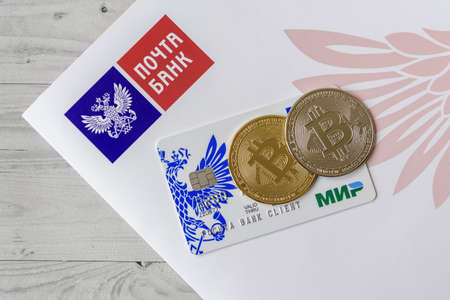 Moscow, Rissia - February 11, 2021: Pochta Bank debit card Mir and corporate logotype of Pochta Bank. Russian commercial bank.のeditorial素材
