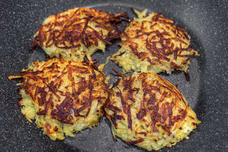 Hash brown from potatoes on a pan, well fried. Food concept.の写真素材