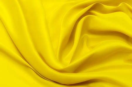 Texture, background, pattern. Texture of yellow silk or cotton or wool fabric. Beautiful pattern of fabric.の写真素材