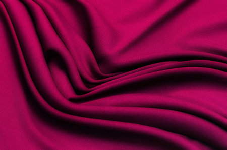 Texture, background, pattern. Texture of red silk or cotton or wool fabric. Beautiful pattern of fabric.の写真素材
