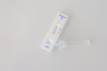 A covid-19 antigen PCR express test close up isolated on gray background. The test showed a negative...
