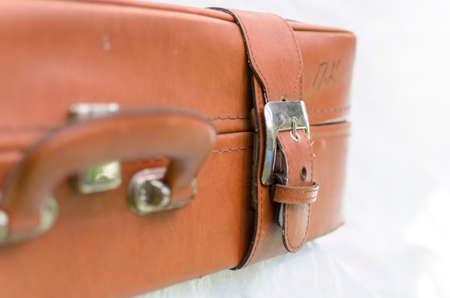Close up of an old brown leather briefcase on a white backgroundの写真素材