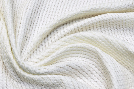 Cotton fabric matlasse ivory in the artistic layout. Texture, background, pattern.の写真素材