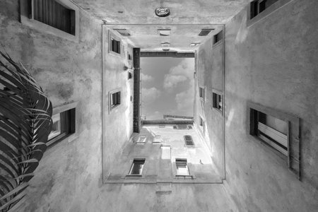 Bottom wide angle view of historic inner courtyard with beautiful facade building complex with blue...
