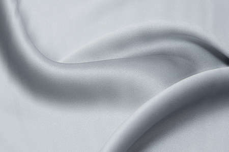 Close-up texture of natural gray fabric or cloth in gray color. Fabric texture of natural cotton or linen textile material. Gray canvas backgroundの写真素材