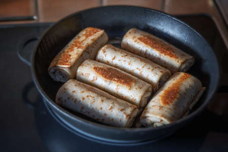 Tasty stuffed pancakes crepes with meat closeup. Thin pancakes with minced chicken. Russian Fried Stuffed Pancakes with Meat. food photography.の写真素材