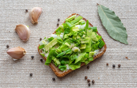 Russian sandwich: brown bread with butter and green onions on cotton background, top viewの写真素材