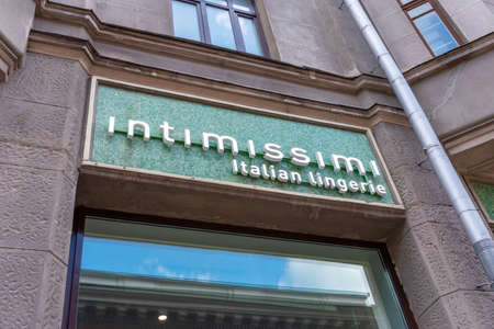 Moscow, Russia - May 02, 2021: Signboard of Intimissimi on the store facade above window in sunlight. Sign of popular italian manufacturer of lingerie and beachwear Intimissimi on the green boardのeditorial素材