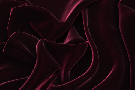 Dark red velvet fabric background texture.の写真素材