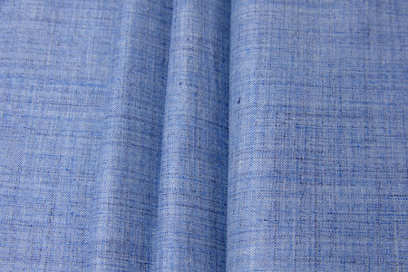 Cotton fabric denim blue background. Draped soft cotton jeans blue fabric texture.の写真素材