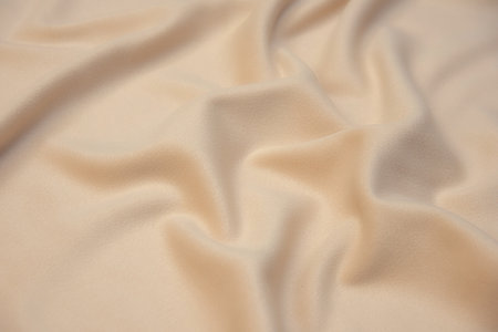 Close-up texture of natural beige fabric or cloth in brown color. Fabric texture of natural wool textile material. Beige canvas background.の写真素材