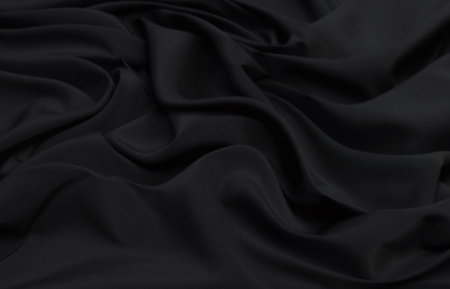 Black satin texture background. Abstract dark wavy fabric background.の写真素材