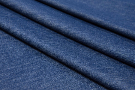 Abstract background texture of natural blue color fabric. Fabric texture of natural cotton or linen, silk or satin, wool or jersey textile material. Luxurious blue canvas background.の写真素材
