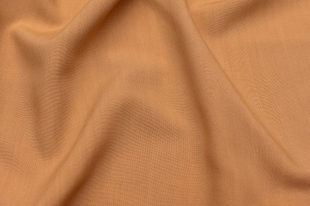 Abstract background texture of natural beige or brown color fabric. Fabric texture of natural cotton or linen, silk or satin, wool or jersey textile material. Luxurious canvas background.の写真素材