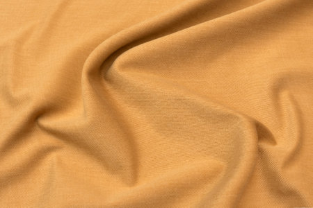 Abstract background texture of natural beige or brown color fabric. Fabric texture of natural cotton or linen, silk or satin, wool or jersey textile material. Luxurious canvas background.の写真素材