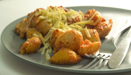 Pasta with tomato sauce and cheese on top の写真素材