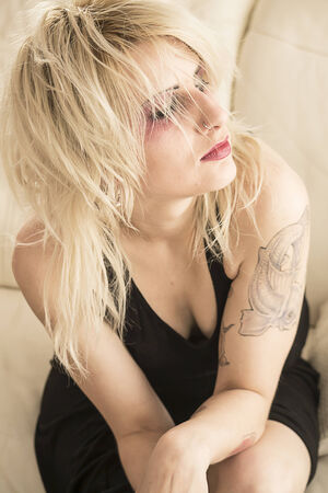 Young woman with piercings posing の写真素材