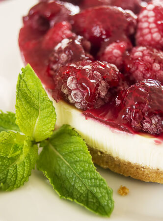 Fresh raspberry cheesecake served with mint leaves の写真素材