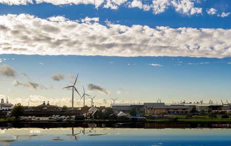 Industrial landscape with a blue sky and white clouds.の写真素材