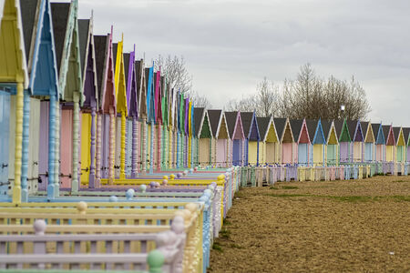 Colorful cute beach houses on the shore in England.のeditorial素材