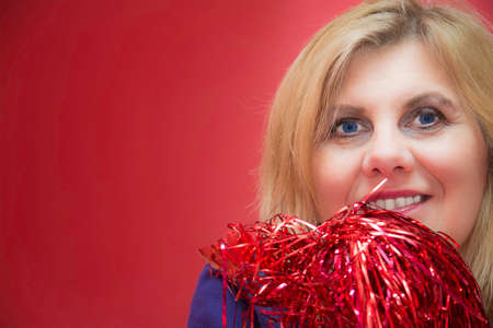 Pretty middle-aged blonde woman with Christmas decoration.の写真素材