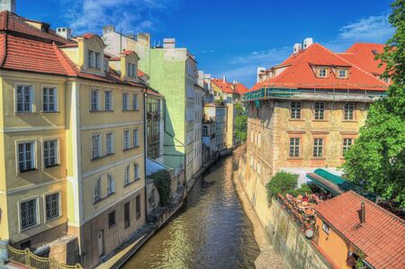 Streets of Prague with a small river between the buildings.の写真素材