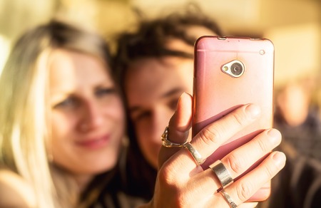 Young couple taking a selfie with a smartphone.の写真素材