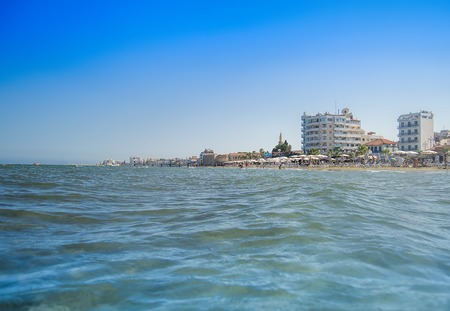 Azure blue Larnaca beach popular with tourists and holidaymakers.の写真素材