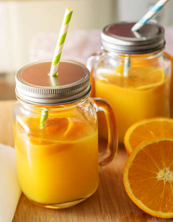 Fresh orange juice on a wooden table.の写真素材