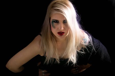 Portrait of an attractive blonde woman against a dark backgroundの写真素材