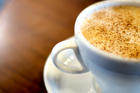 Cup of cappuccino on a wooden table.