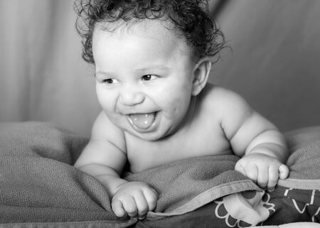 Black and white portrait of a laughing baby boy.の写真素材