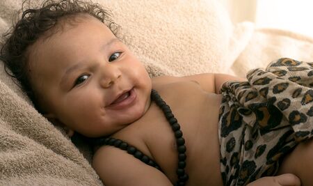 Portrait of a mixed race happy baby boyの写真素材