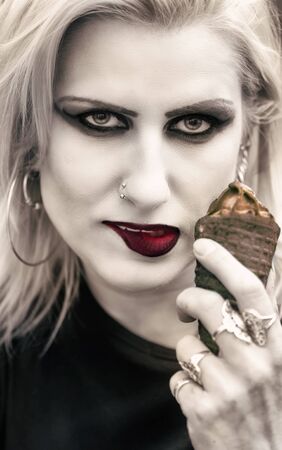 Mysterious blonde woman with chocolate ice cream.の写真素材