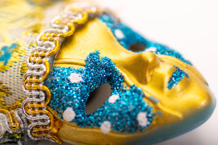 Golden Venetian mask closeup image on a white background.の写真素材