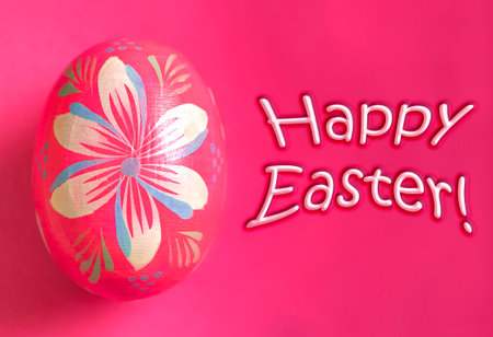 Happy Easter greeting with a pink painted eggの写真素材