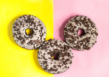 Three donuts on a split colored background