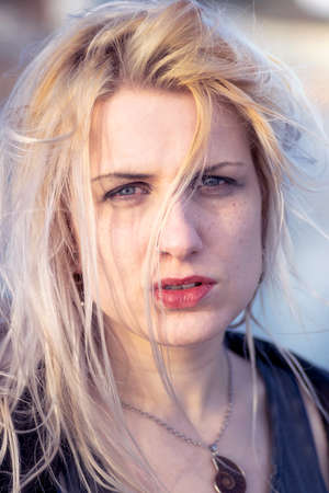 Blonde woman with blonde hair, blue eyes and freckles.の写真素材