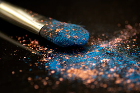 Blue and orange powdered eye shadow and brush closeupの写真素材